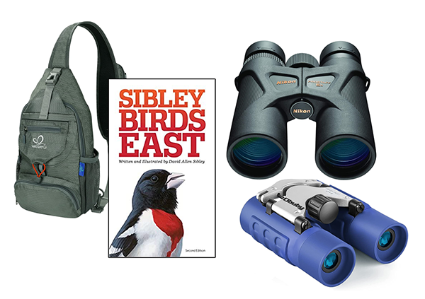 A kit consisting of two binoculars, a book, and a carrying bag
