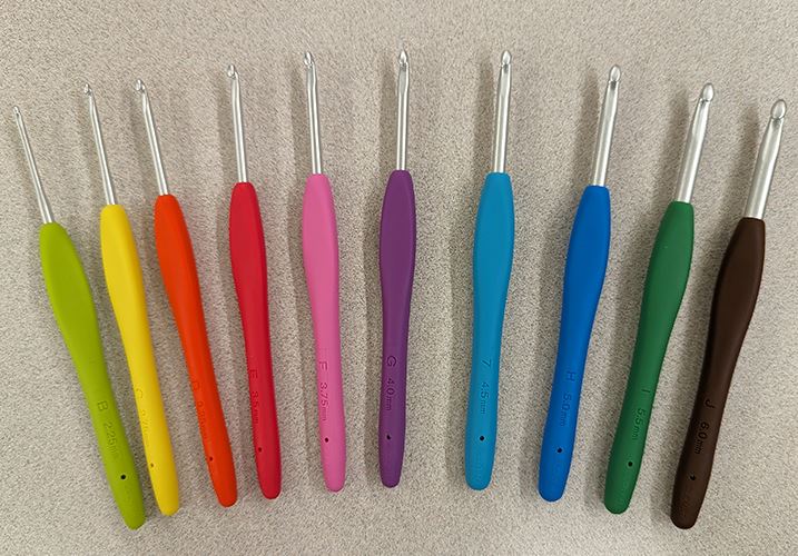 A photo of a collection of differently sized hooked metal rods ending in a silicon handgrip.
